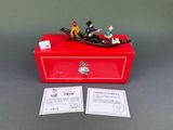 figurines of people in a boat on a red box on a table