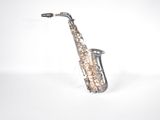 a silver saxophone that is sitting on a white surface