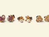 three pairs of earrings are shown in a row on a white surface