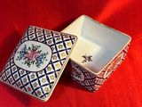 two small boxes are sitting on a red table cloth