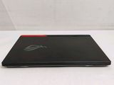 the laptop is sitting on a white surface with a red edge