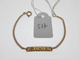 a close up of a gold bracelet with a price tag on it