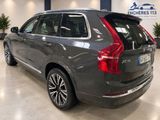 the back end of a grey volvo suv parked in a showroom