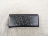 black leather wallet with a braided design on the front