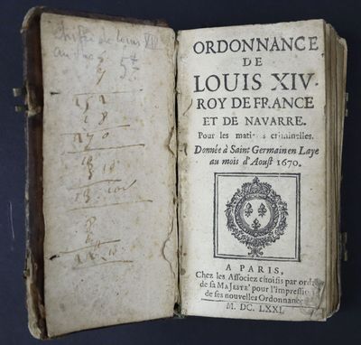 an old book with writing on it sitting on top of a table
