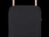 the black suitcase is sitting upright on the black surface