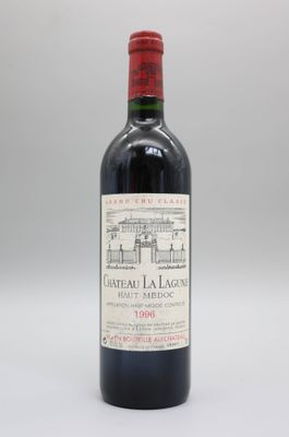 une bouteille de vin rouge posée sur une table blanche