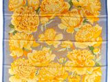 un foulard à motifs floraux jaunes et bleus, orné de fleurs jaunes