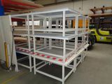 many shelves in a warehouse with a forklift in the background