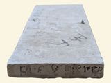 a cement block with writing on it on a white background