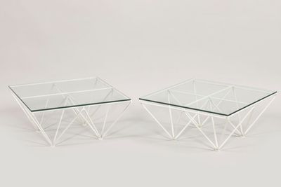 a pair of glass coffee tables with a geometric design