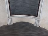 a chair that has a seat made of wood and a seat made of fabric