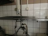 a kitchen with a sink and a metal counter top