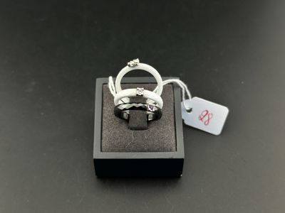 a close up of a ring on a black box with a price tag