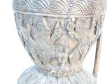 a silver vase with carvings on it on a white background