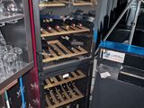 a refrigerator with many bottles of wine inside of it