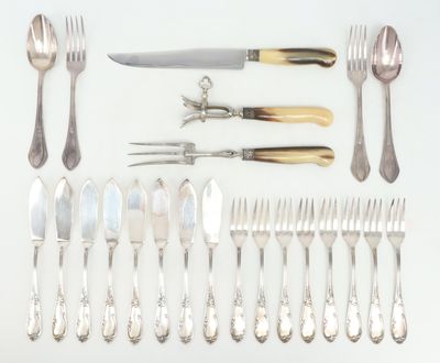 many different types of silverware laid out on the table
