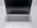 an open laptop computer sitting on top of a white table
