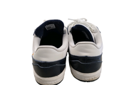 a pair of white and blue sneakers on a white surface