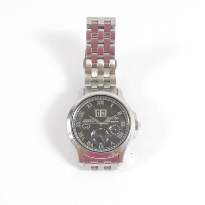 une image d'un gros plan d'une montre-bracelet sur une surface blanche