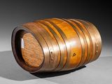an old wooden barrel sitting on top of a gray surface