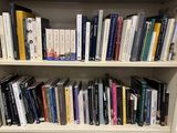 a book shelf with many books on it in a library