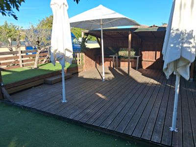 a wooden deck with umbrellas and chairs on it