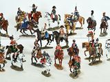many figurines of men riding horses and horses