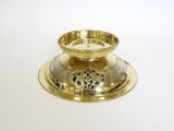 brass plated candle holder on a white surface with a white background