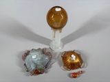 three pieces of glass sitting on a white surface