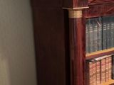 a book shelf with many books on it in a room