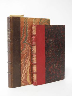 three books are stacked on top of each other on a white surface