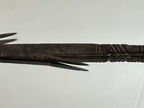 a metal arrow on the wall pointing to the right
