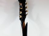 a guitar that is sitting on a stand in the room
