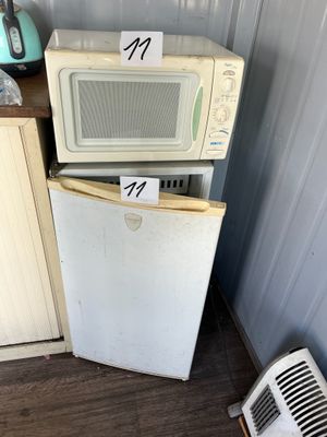 two microwaves stacked on top of each other in the kitchen
