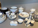 a table with a lot of dishes and cups on it