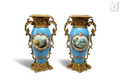 une paire de vases bleus ornés de motifs dorés et d'une peinture