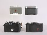 three cameras that are sitting next to each other on a table