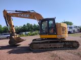 a picture of a yellow and black excavator parked in a parking lot