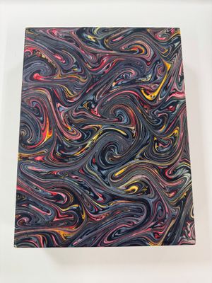 a close up of a painting on a white surface with a black background