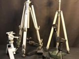 three tripods and a camera on a table