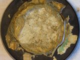 a pan with a pancake in it sitting on a table