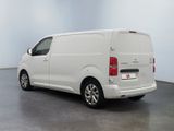 the white van is parked in the empty room of the building