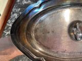 a silver plate with a handle on a table