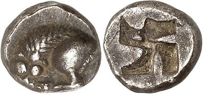 a silver coin with an image of a man and a cross on it