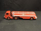 a red toy truck with a white stripe on the side