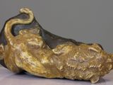 a sculpture of a cat that is sitting on top of a table