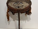 a small wooden table with a face on it