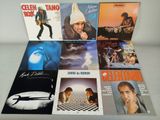 a group of music cds including a cd, a cd, and a picture of a man playing a guitar