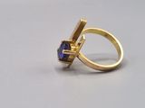 a gold ring with a tan sapphire stone in it